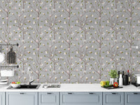 Magnolia blossom wallpaper behind a white kitchen counter with fresh vegetables.