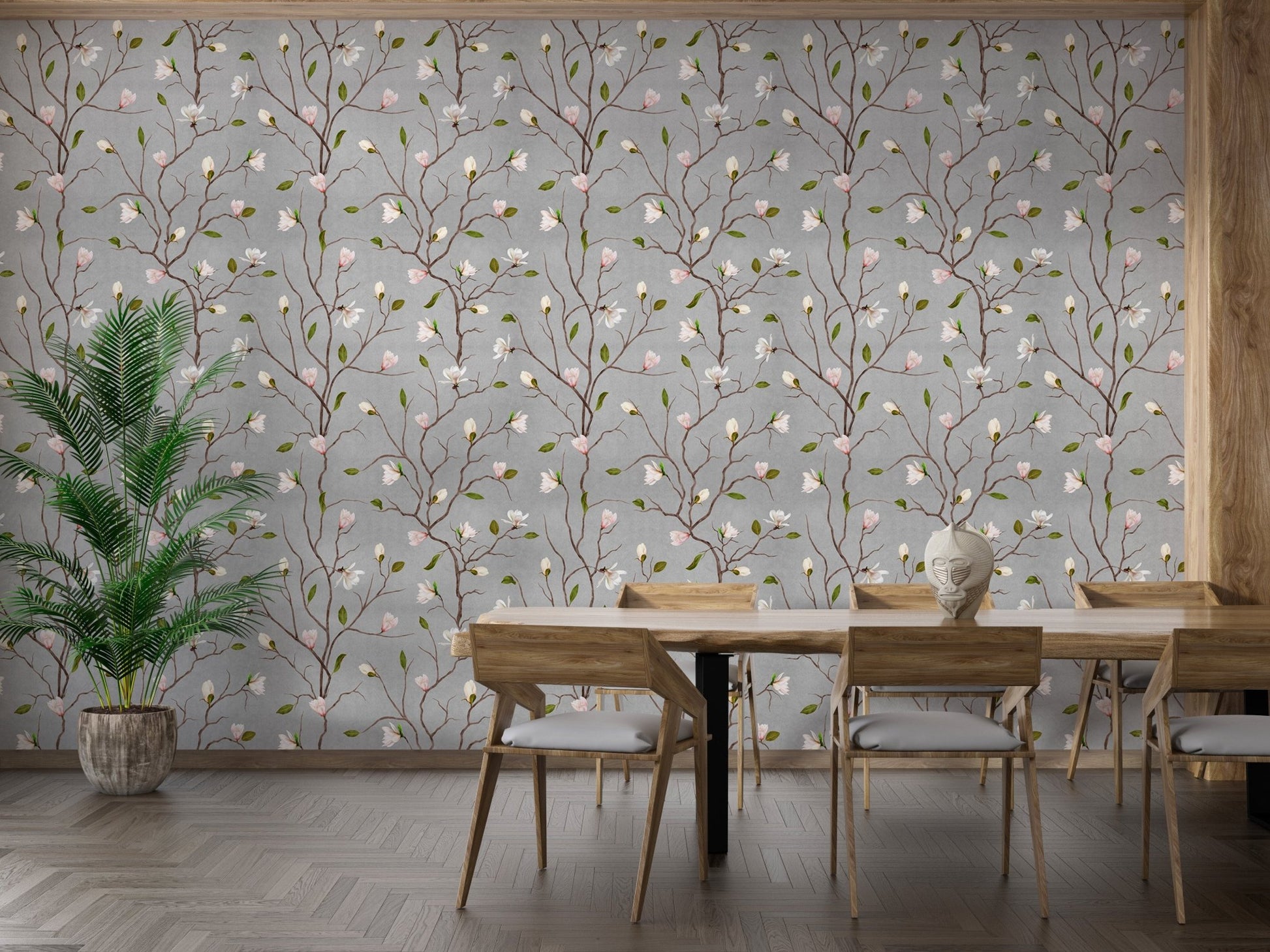 Grey botanical wallpaper in a dining room with a long wooden table and chairs.