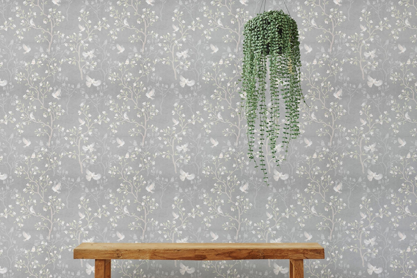 Hanging plant against a grey Chinoiserie wallpaper in a bright interior.