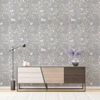 Grey Chinoiserie wallpaper with magnolia trees behind a modern wooden sideboard.
