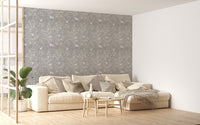 Large living space featuring a grey magnolia tree wallpaper with a white sofa.