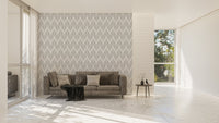 Grey leaf wallpaper on a living room wall with a modern grey sofa.