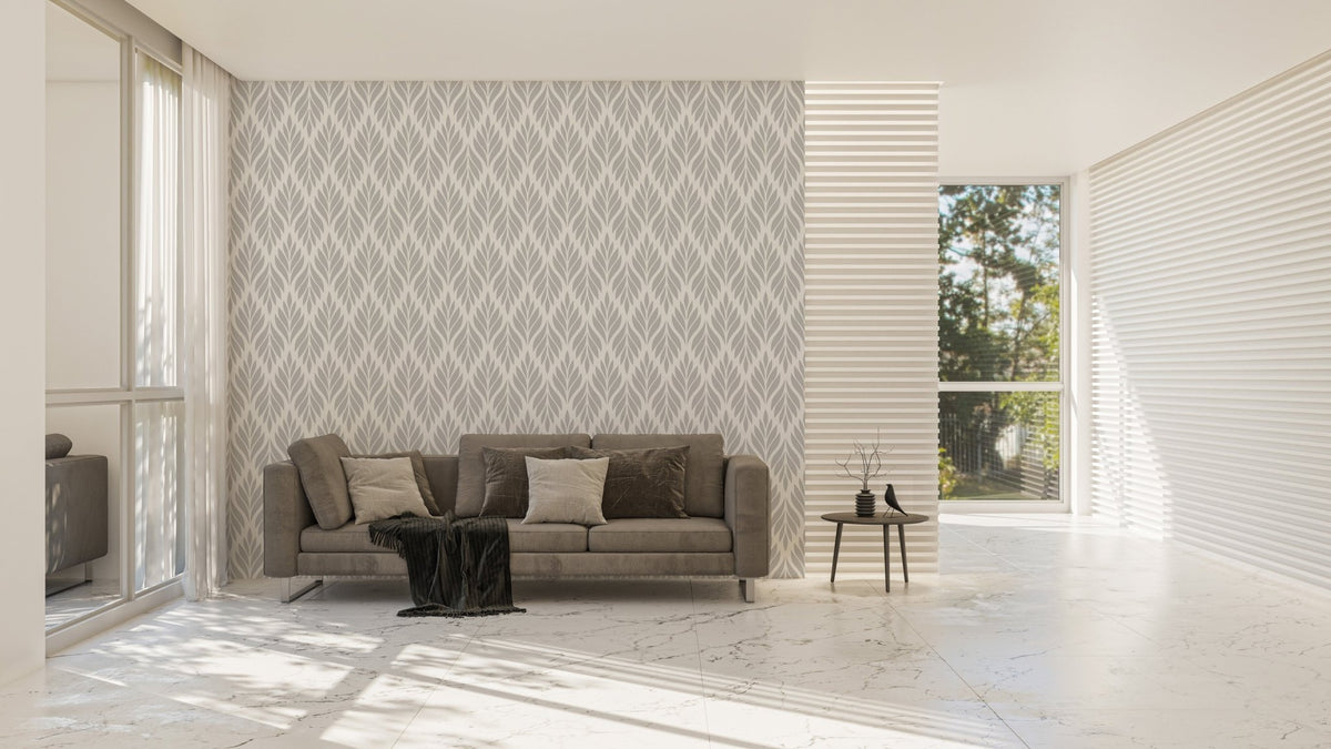Grey leaf wallpaper on a living room wall with a modern grey sofa.