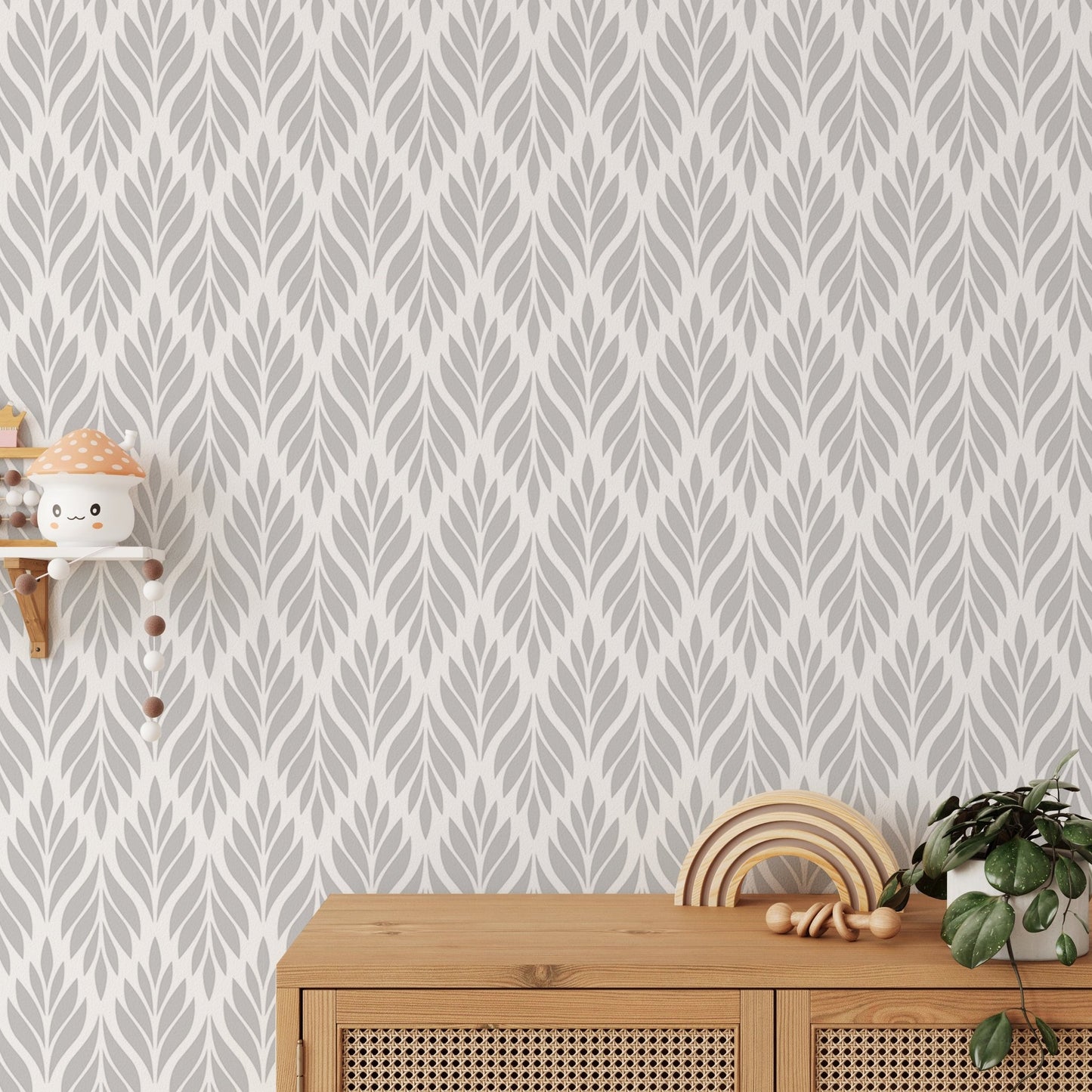 Grey color leaves damask design wallpaper behind a wooden sideboard.