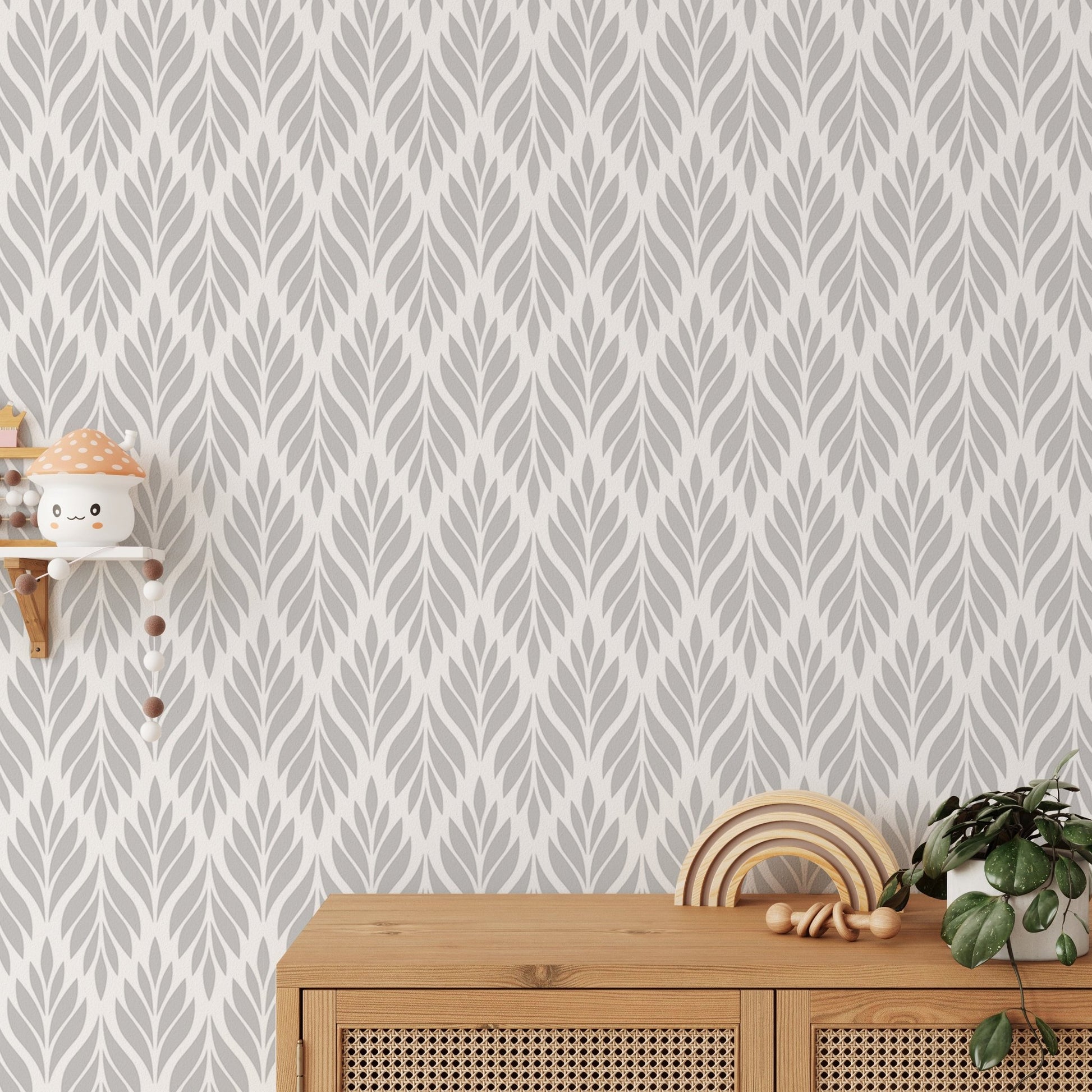 Grey color leaves damask design wallpaper behind a wooden sideboard.