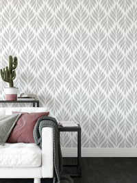Geometric leaf wallpaper in a bright living area with a white sofa.