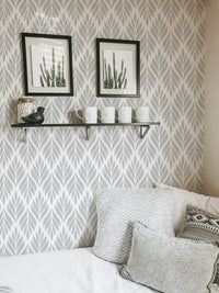 Modern grey leaf pattern wallpaper in a minimalist guest room.