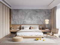 Vintage style charcoal forest mural behind a wooden bed frame in a master bedroom.