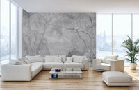 Minimalist grey nature wall mural in a bright living with floor-to-ceiling windows.