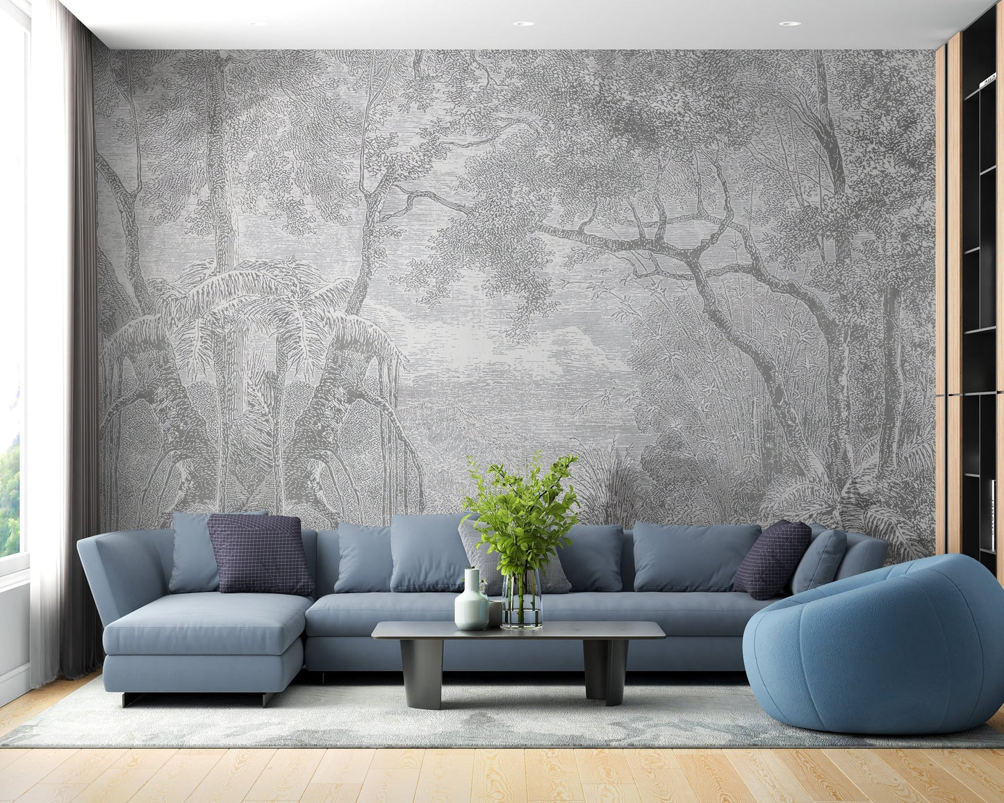 Grey etched tree wall mural in a living room with a blue sofa and wooden flooring.