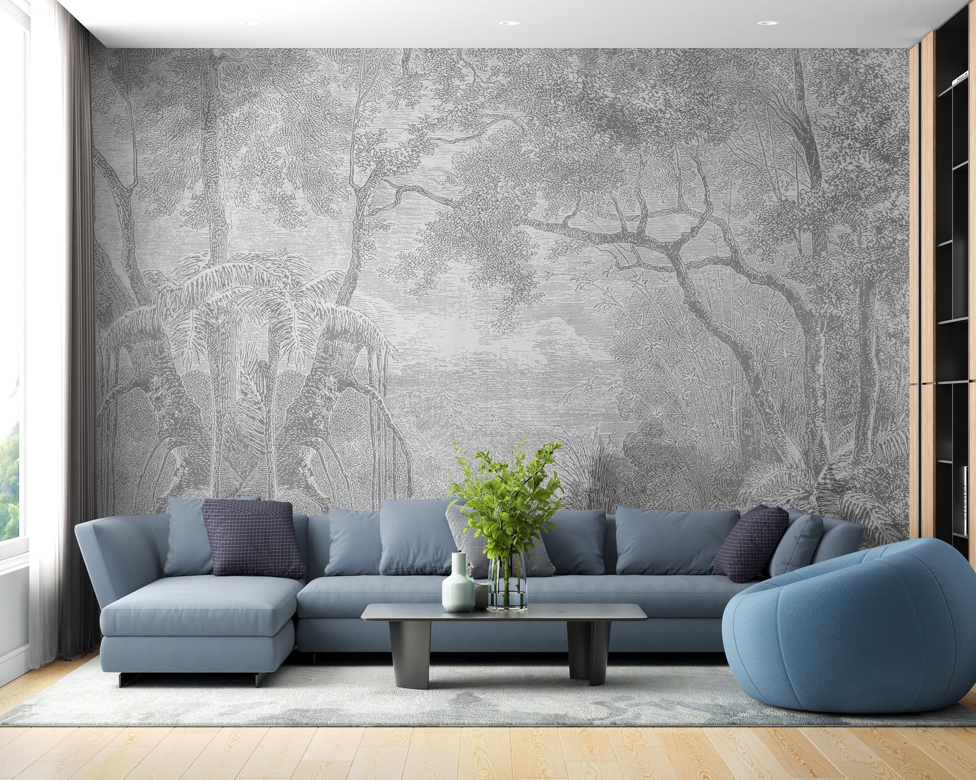 Grey etched tree wall mural in a living room with a blue sofa and wooden flooring.