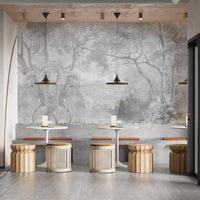 Grey color nature view sketch forest wall mural in a cafe with wooden stools.