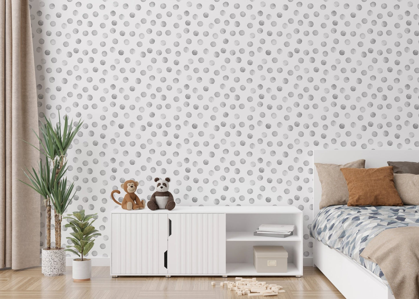 Bedroom with white storage unit and grey polka dot wallpaper.