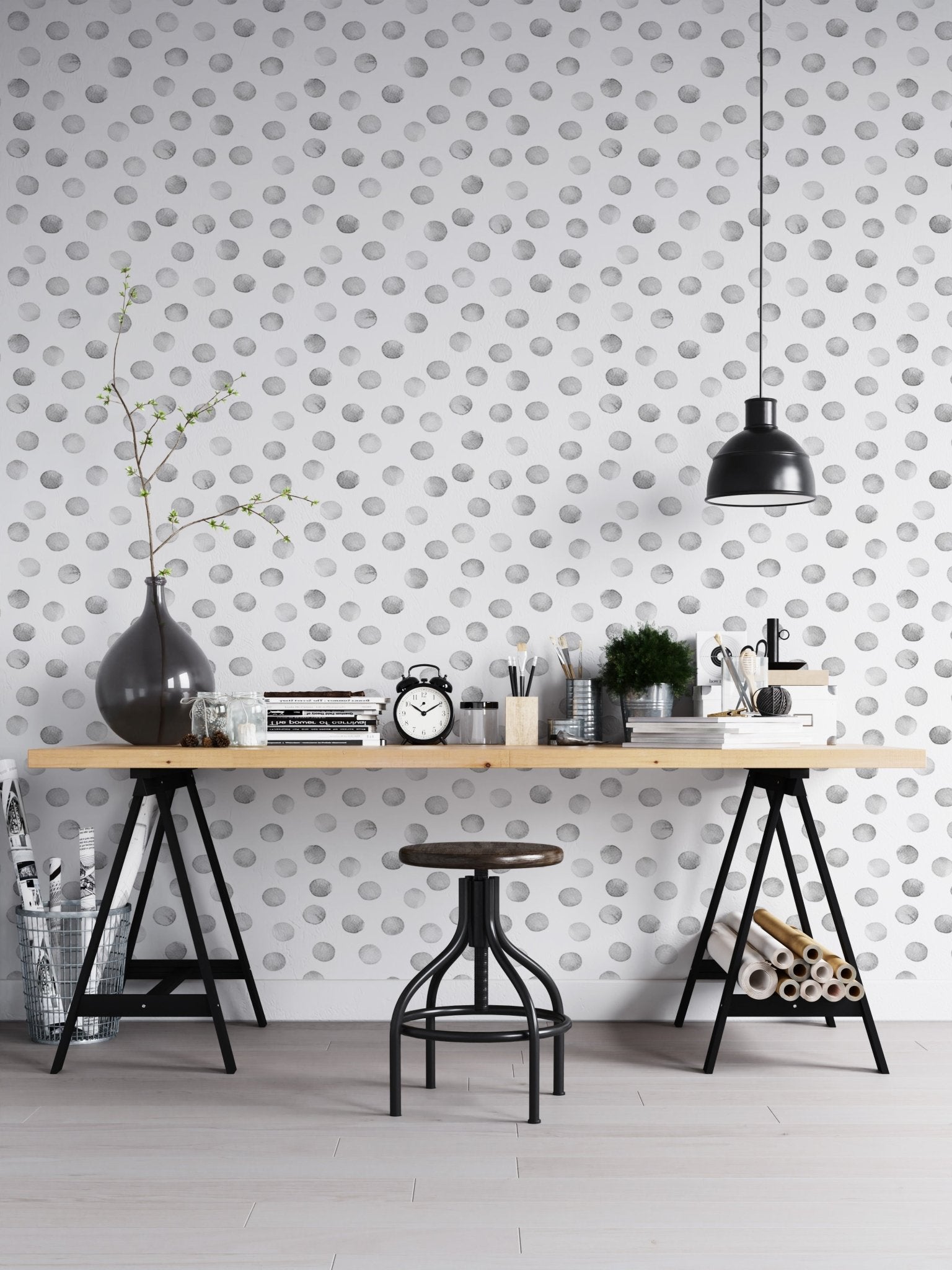 Industrial office with black trestle desk and grey polka dot wallpaper.