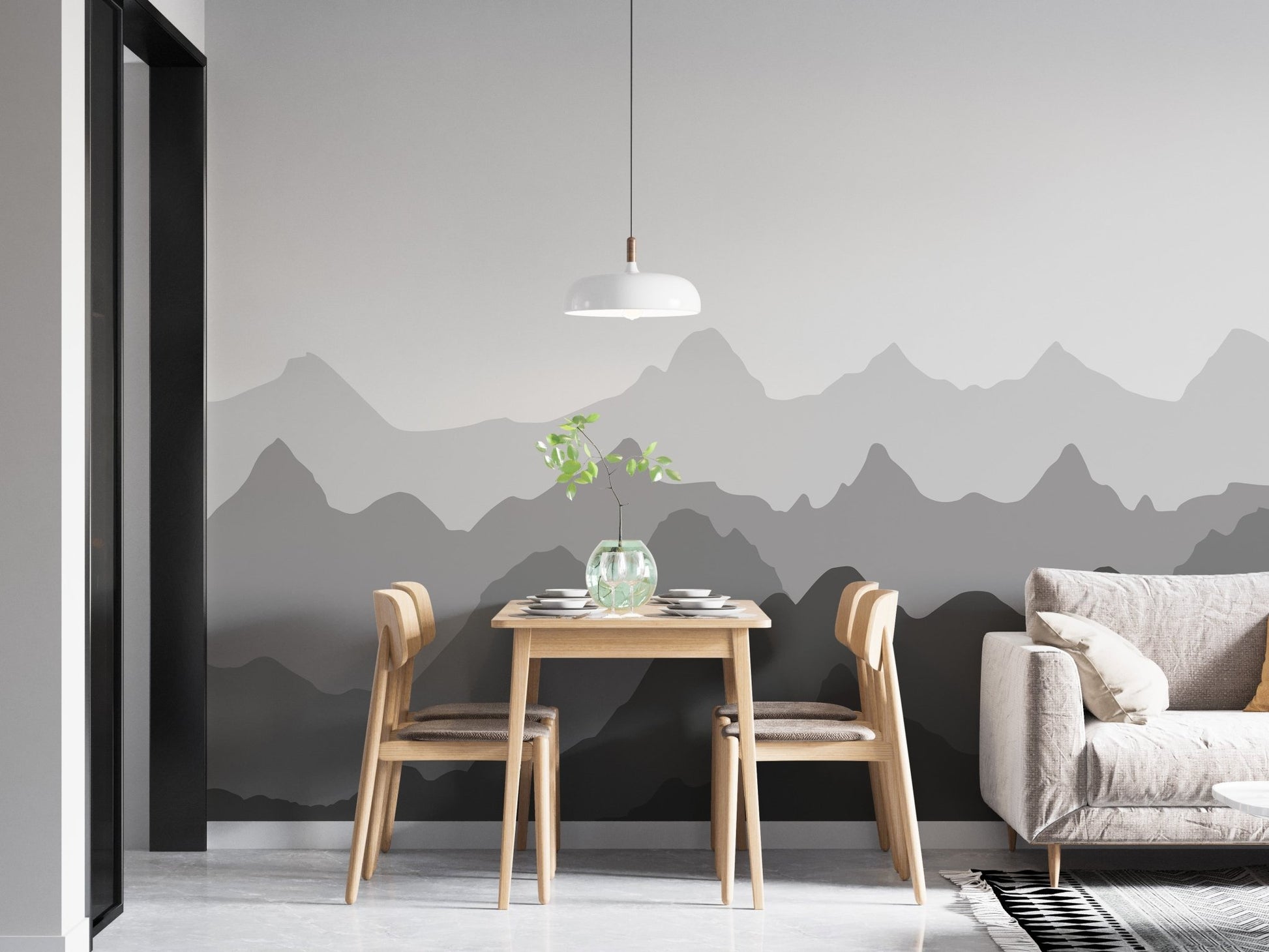 Neutral dining room with a grey mountain shadows wall mural and wooden table.