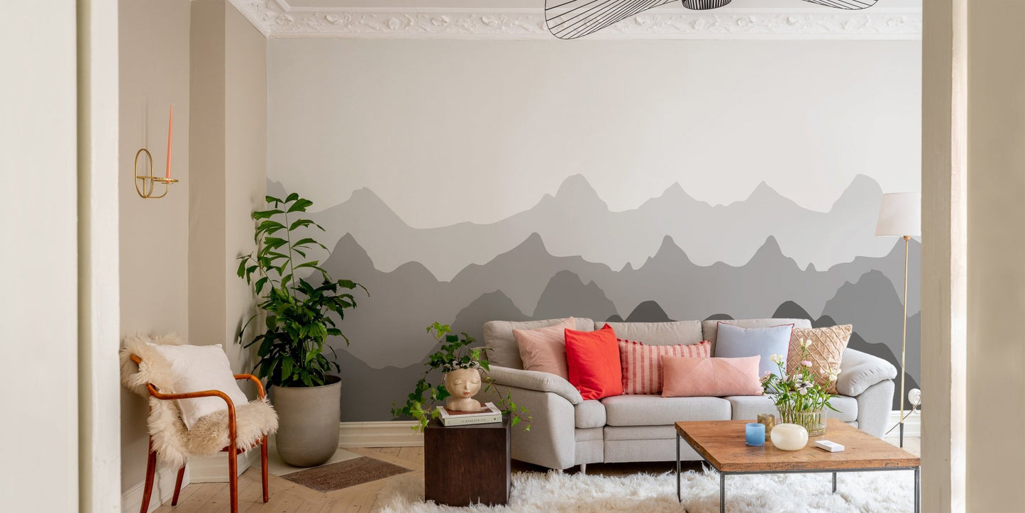 Modern living room featuring a grey mountain wall mural behind a light sofa.