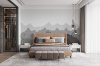 Grey mountain shadows wall mural in a minimalist bedroom with a wooden bed.