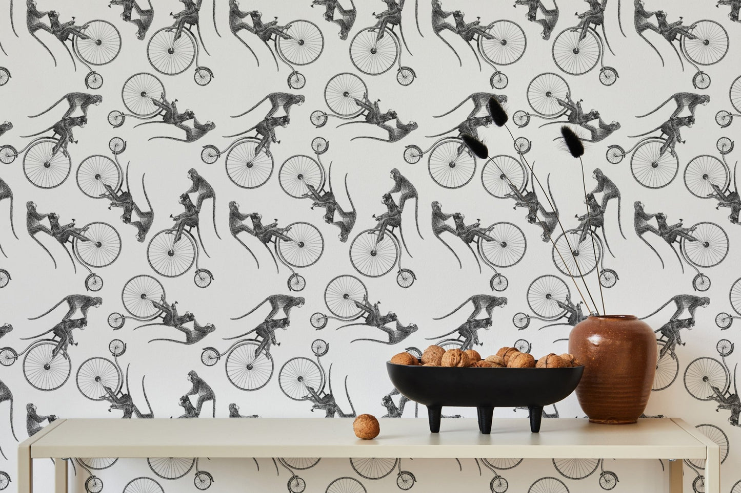 Sketch style monkey on bike wallpaper decorated with a bowl of fruit on a table.