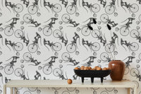 Sketch style monkey on bike wallpaper decorated with a bowl of fruit on a table.