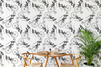 Hand Drawn Monkey on Bike Repeat Pattern Wallpaper in a dining area with wooden chairs.
