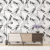 Hand drawn monkey on bike wallpaper above a modern wooden sideboard cabinet.