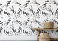 Hand Drawn Monkey on Bike Repeat Pattern Wallpaper behind woven storage baskets.