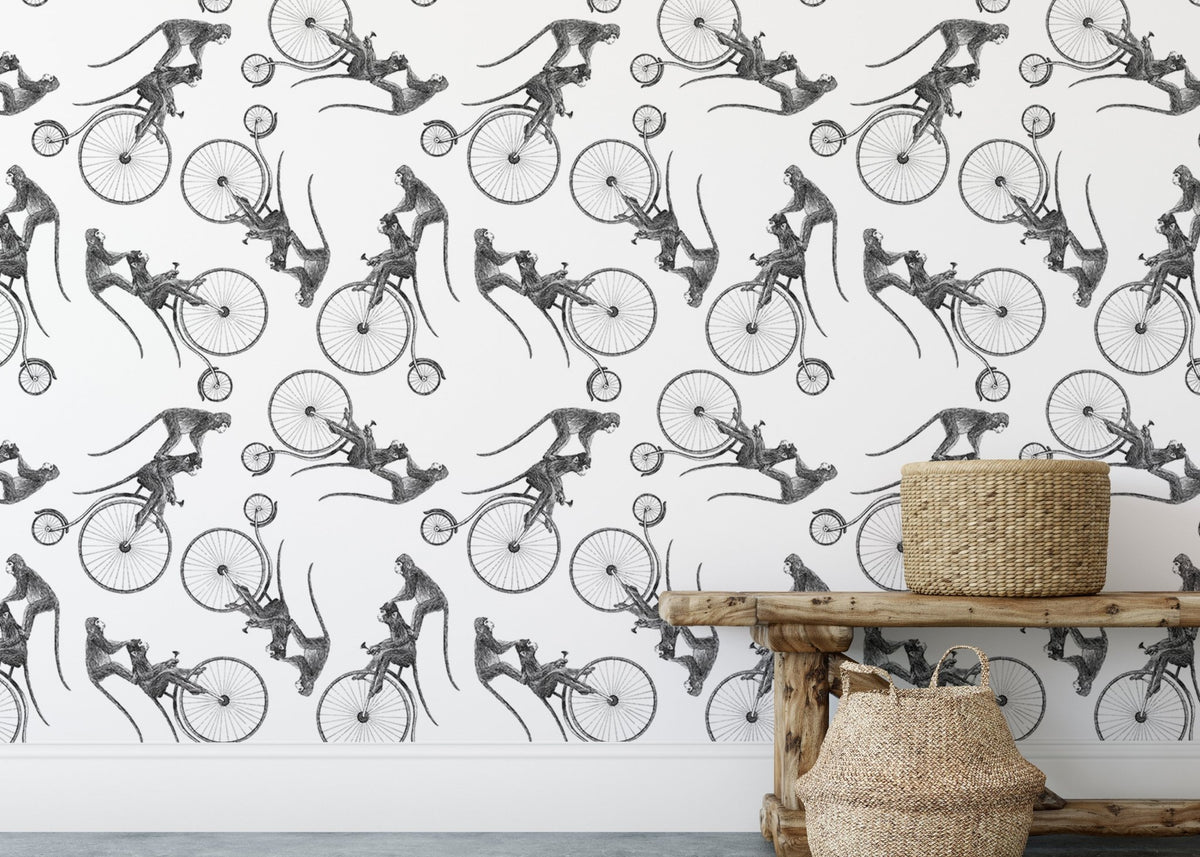 Hand Drawn Monkey on Bike Repeat Pattern Wallpaper behind woven storage baskets.