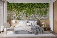 Stone wall and ivy leaves wallpaper mural in a modern bedroom with neutral bedding.