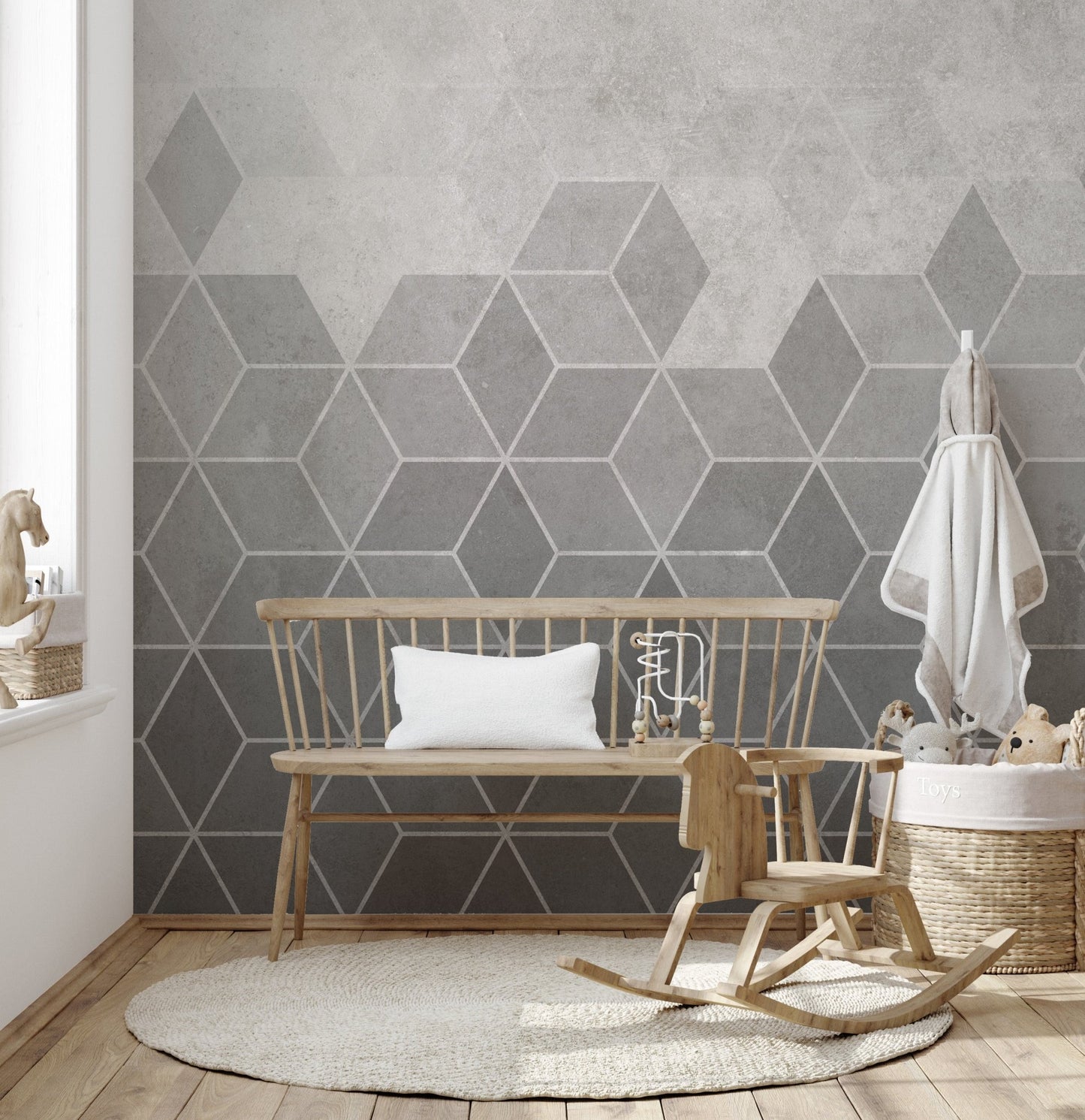 Grey geometric wall mural in a kids' nursery with a wooden rocking horse.