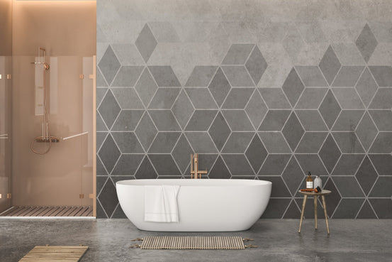 Hexagon Concrete Charm wall mural behind a white bathtub in a modern bathroom.