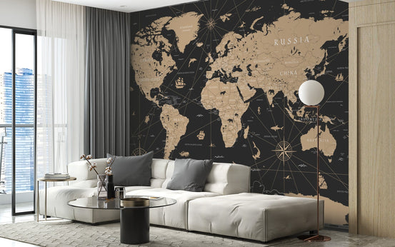Historical Gold-Leaf World Map wall mural in modern living room with black and gold wallpaper.