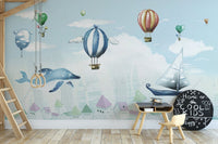 Watercolor hot air balloon wall mural in kids room with wooden chair.