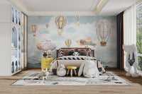 Artistic sky adventure wall mural with watercolor balloons.
