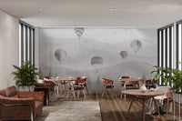 Gray-themed mural with balloons and forest scene in restaurant.