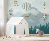 Mountain peak wall mural in modern nursery with hot air balloon pattern.