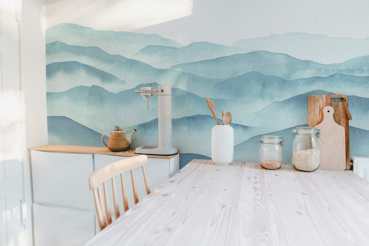 Modern kitchen island setup with indigo blue watercolor waves wall mural.