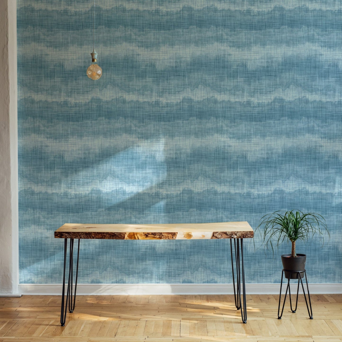 Indigo marine texture wallpaper behind a thin metal desk and lamp.