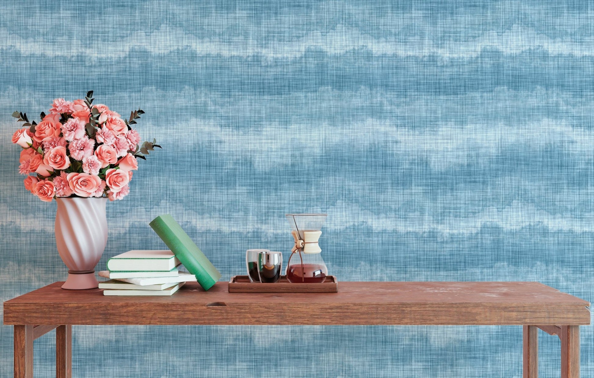 Wavy blue stripe wallpaper behind a wooden desk with a flower vase.