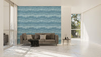 Horizontal blue wave wallpaper on a large feature wall in a minimalist living room.