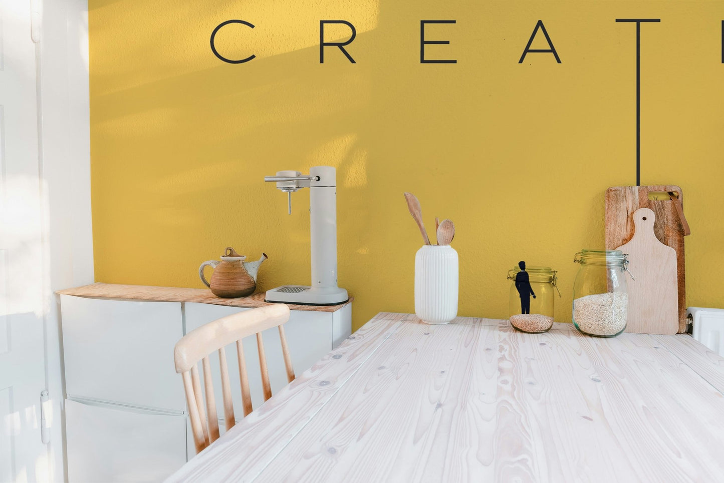 Minimalist creative typography wall mural in bold yellow color.