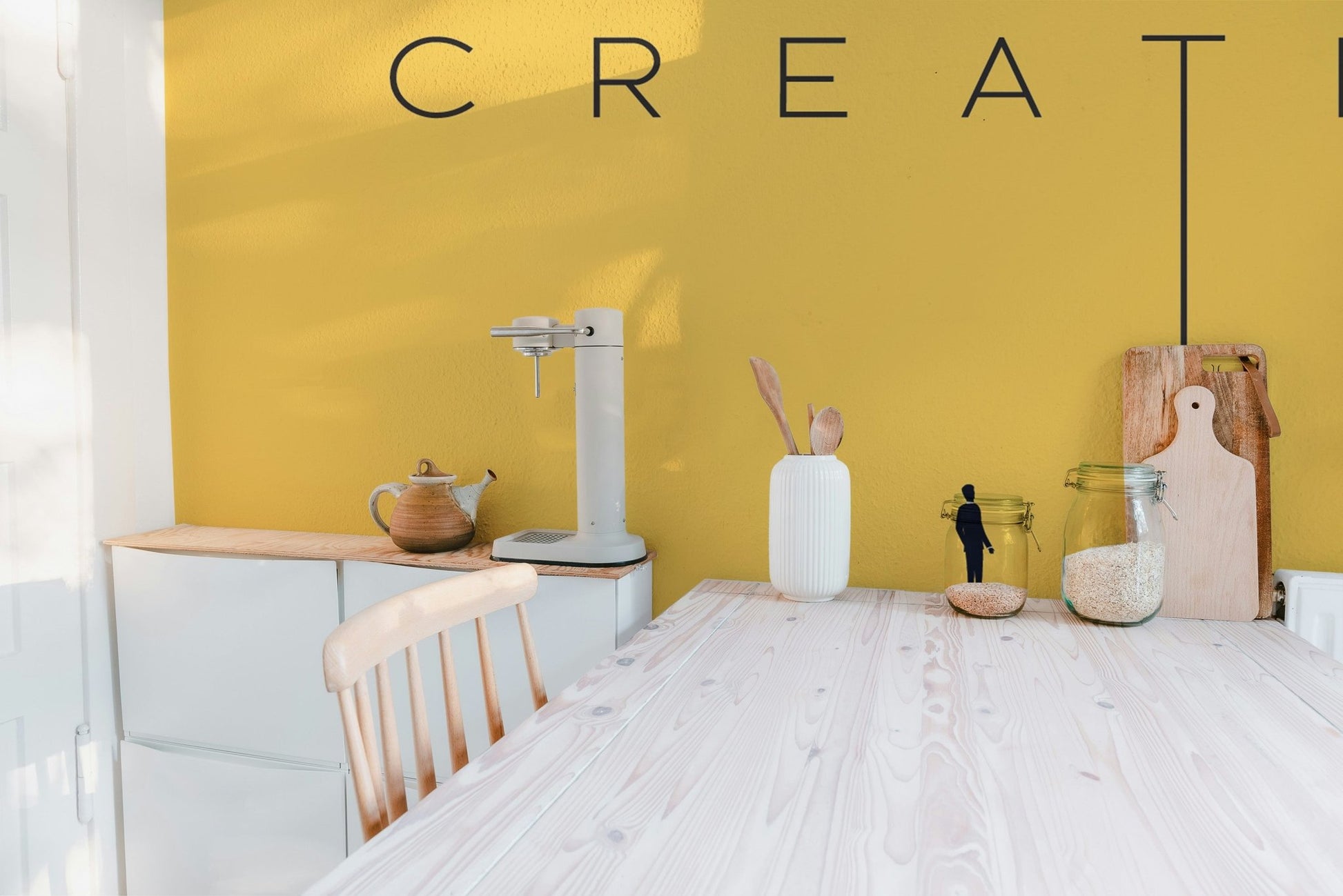 Minimalist creative typography wall mural in bold yellow color.
