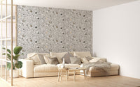 Large living room wall featuring a grey terrazzo pattern wallpaper and white sofa.