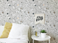 Italian style terrazzo flooring vector grey wallpaper behind a bed with white pillows.