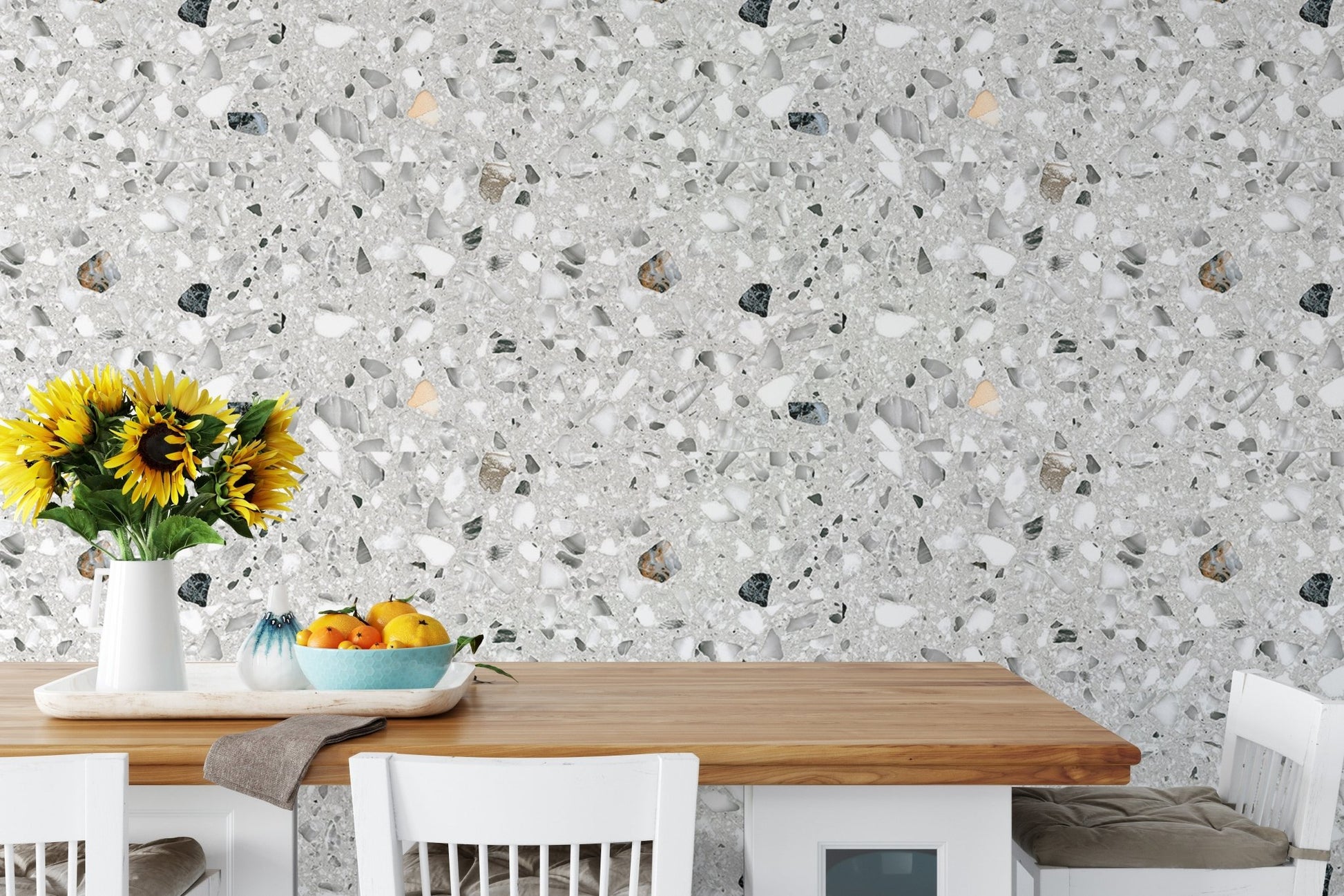 Terrazzo pattern wallpaper in a dining area behind a wooden table with sunflowers.