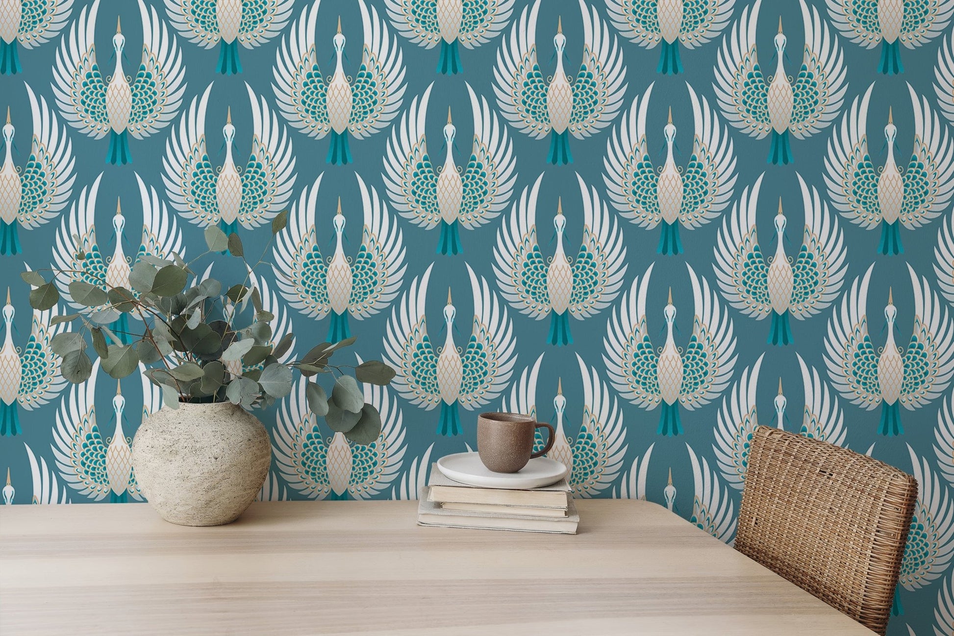 Patterned teal bird wallpaper in a workspace with a potted plant and books.