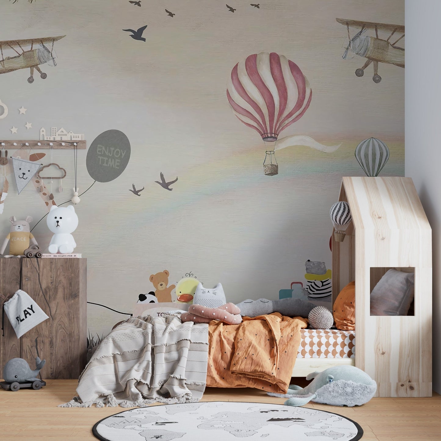Jovial Animal Parade wall mural behind a wooden house-frame bed.