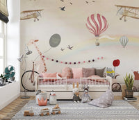 Jovial Animal Parade wall mural behind a toddler daybed with pink cushions.