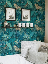 Modern bedroom wall adorned with botanical palm leaf wallpaper.