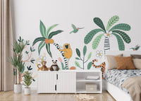 Jungle mural featuring a safari adventure with exotic animals in kids bedroom.
