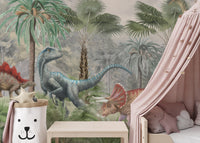 Prehistoric dinosaur wallpaper mural with green botanical accents.
